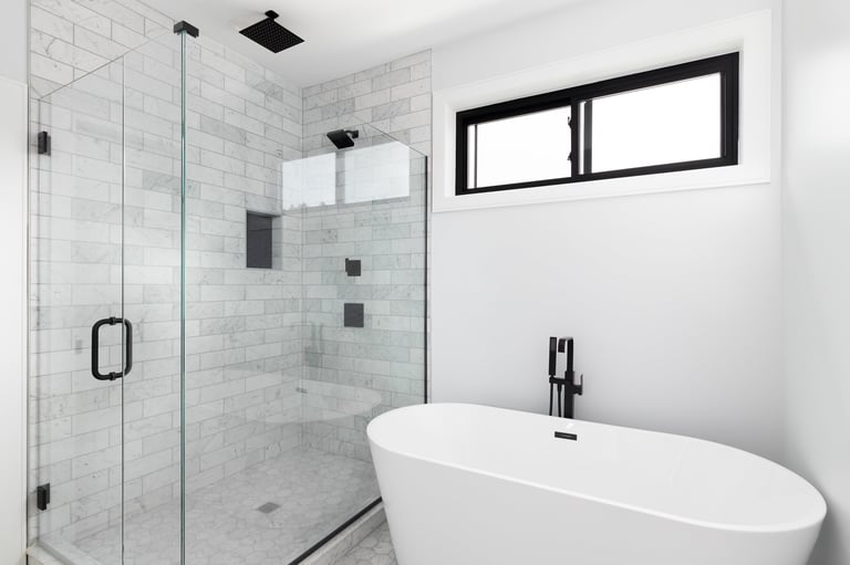 Renovated luxury shower and freestanding bathtub with marble subway tiles