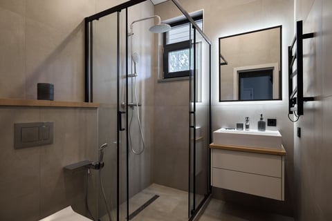 Stylish minimalist bathroom with glass shower