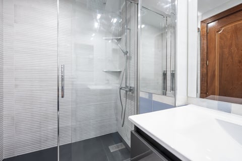 Small bathroom with frameless mirror