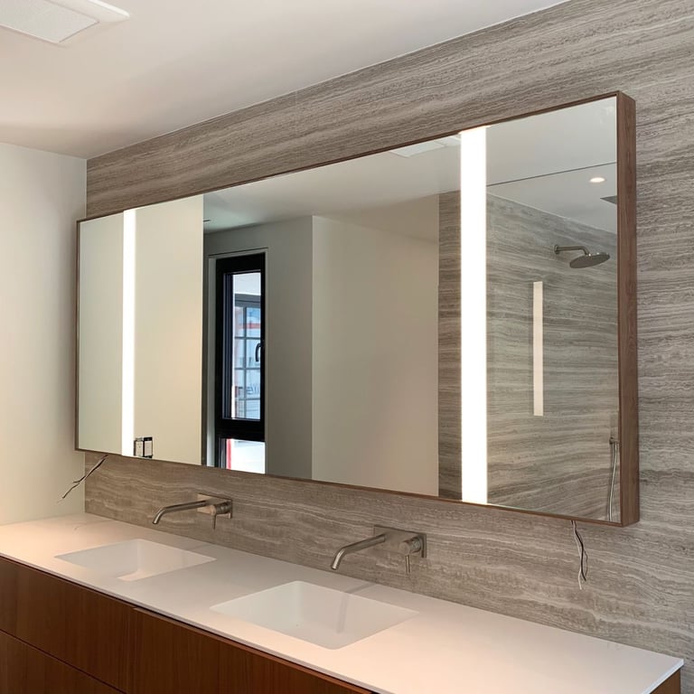 Modern bathroom vanity with large backlit mirror