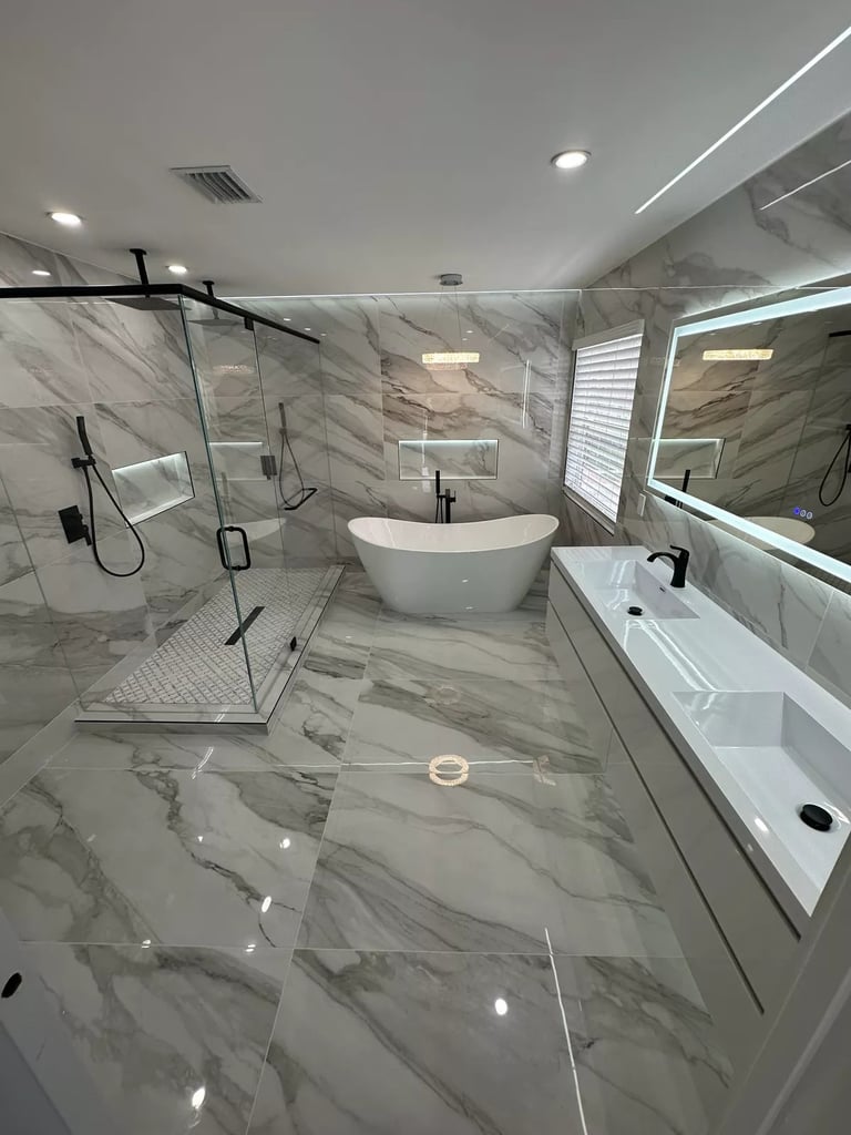 Modern bathroom with glass shower enclosure and freestanding bathtub