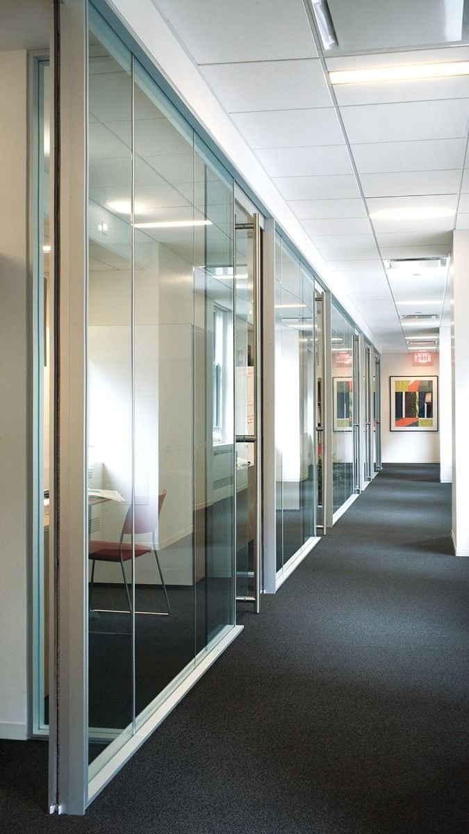 Modern office corridor with glass-walled conference rooms