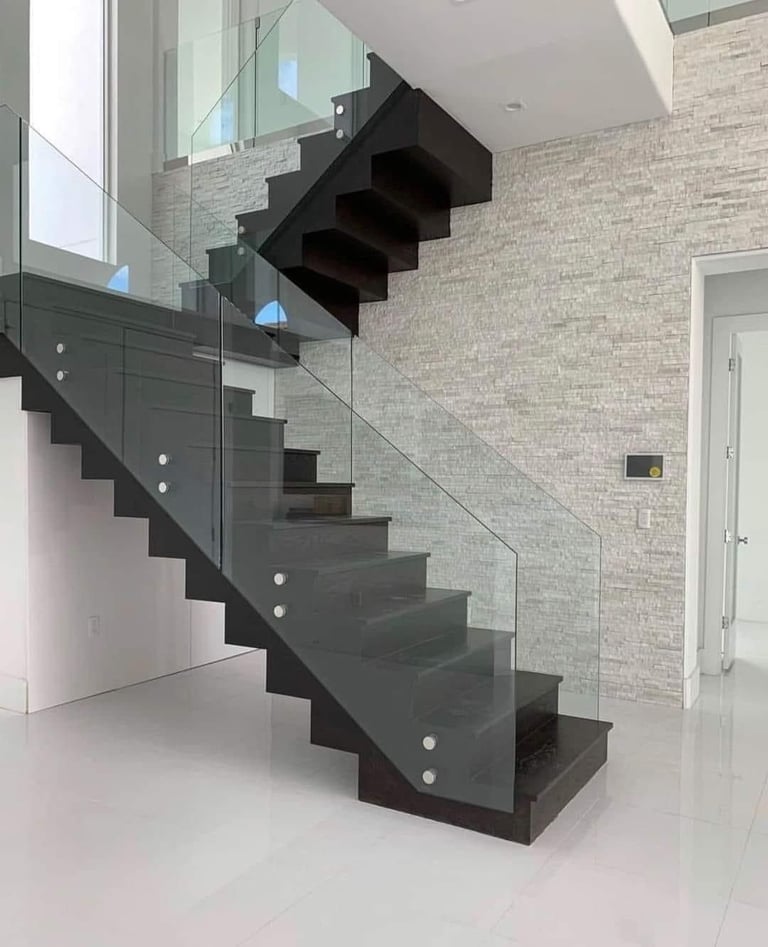 Modern black staircase with glass railing in contemporary interior