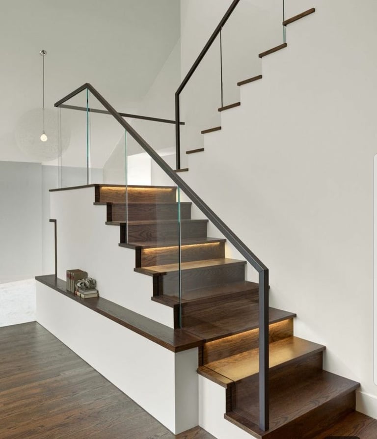 Modern staircase with dark wood steps and metal railings